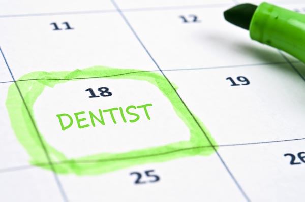 Image of a calendar with a dental appointment on it.