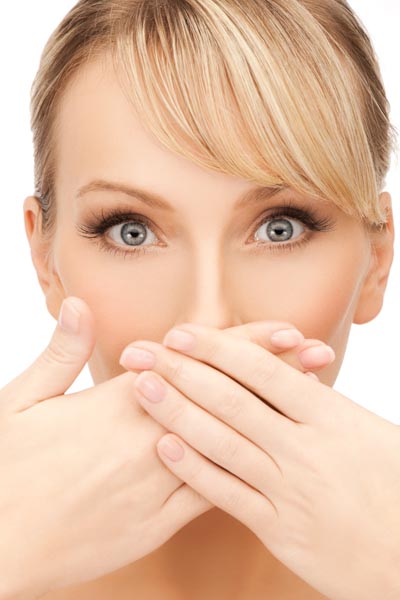 Image of woman covering her mouth to high crooked teeth